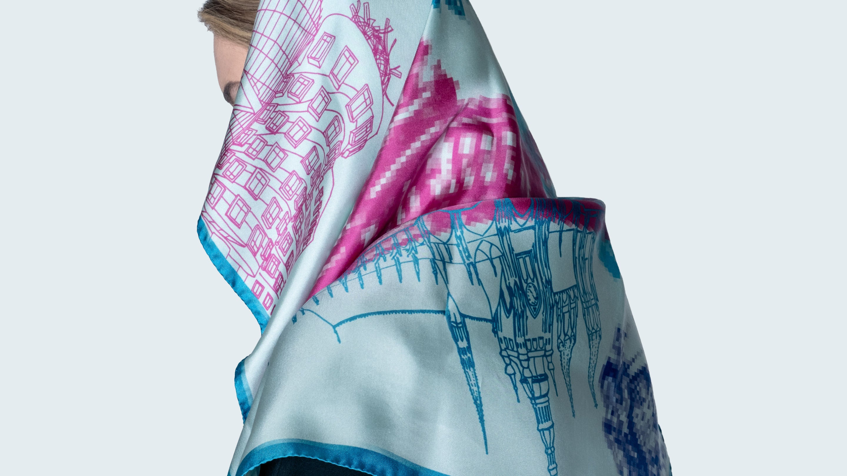 EMBLEMM Square Silk Scarf with Prague motif with Prague monuments 'Distorted Prague' in light green, pink and blue on model