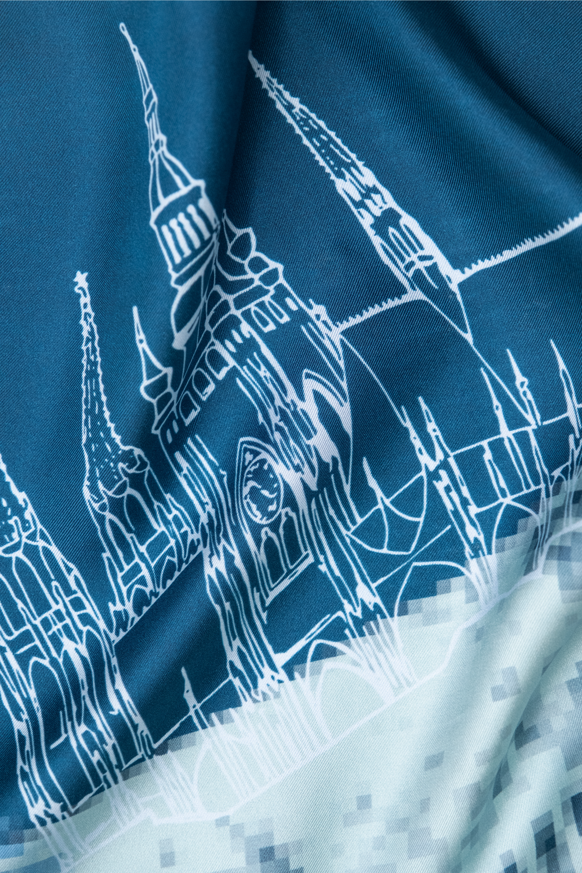 EMBLEMM Square Silk Scarf with Prague Print 'Distorted Prague' with pixelated and hand-drawn Prague Landmarks in Dark Blue, Light Blue and Green Detail